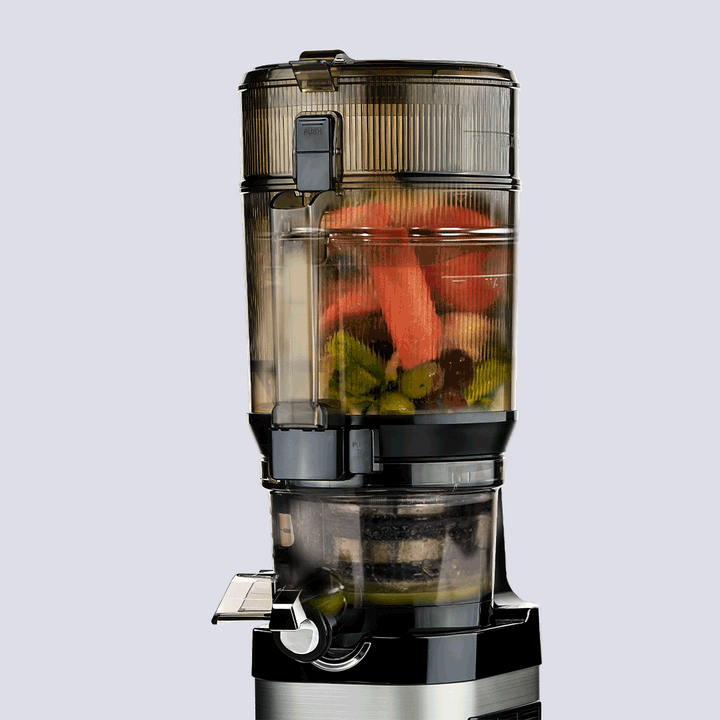 kuvings cs800 in use on a white bacground showing fruit and veg juicing