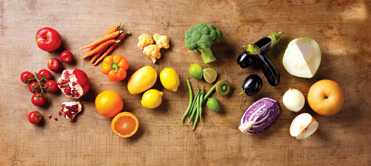 Assorted fruits and vegetables on a wooden surface