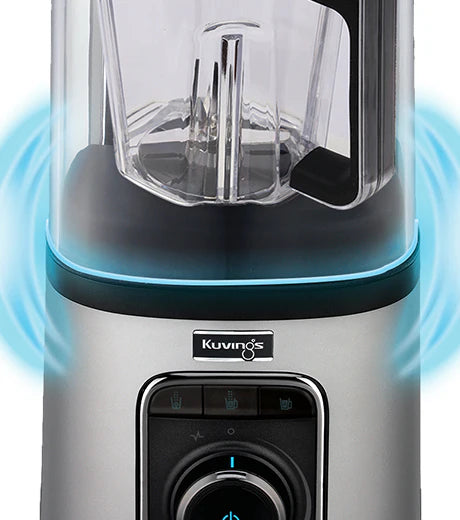 Straight-on close-up view of the silver motor base and clear sound cover of a Kuvings SV-500 vacuum blender, featuring glowing blue wave graphics radiating from the base seal to illustrate its noise reduction functionality against a white background.